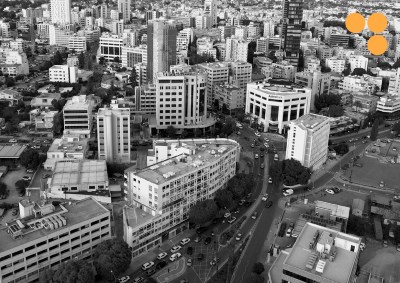 black and white image of a part of Nicosia city centre from above, overlayed with the TWIN2EXPAND logotype