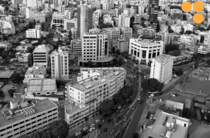 black and white image of a part of Nicosia city centre from above, overlayed with the TWIN2EXPAND logotype